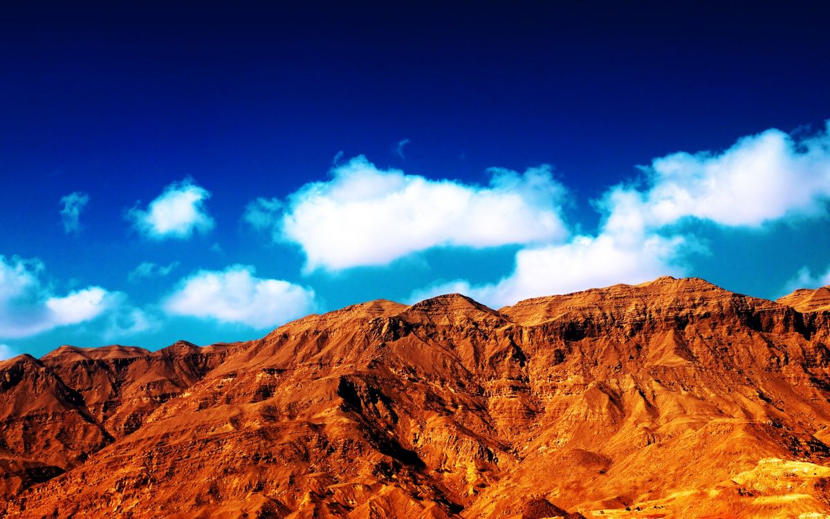 brown rocky mountain under blue sky during daytime