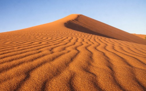 Image brown sand under blue sky during daytime