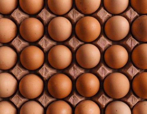 Image brown egg tray on brown wooden table