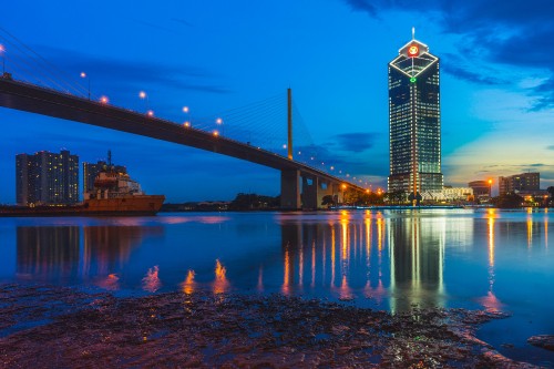 Image lighted bridge over water during night time