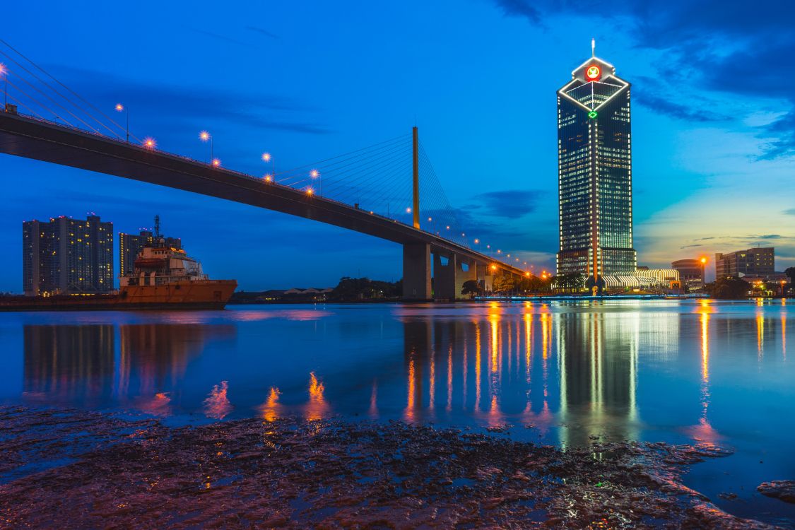 lighted bridge over water during night time