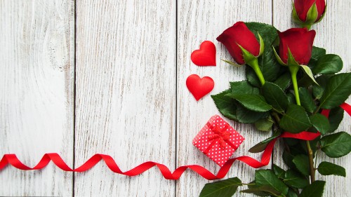 Image red rose on white wooden surface