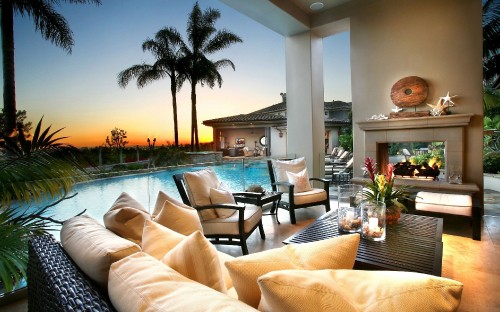 Image brown wooden chairs and tables near palm trees during daytime