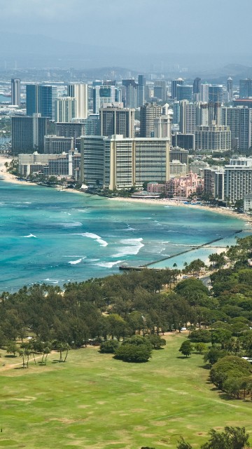 Image aerial view of city buildings near body of water during daytime