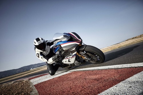 Image man in black and white motorcycle helmet riding black sports bike on road during daytime