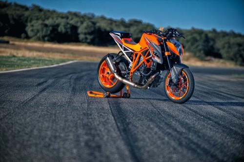 Image orange and black sports bike on road during daytime