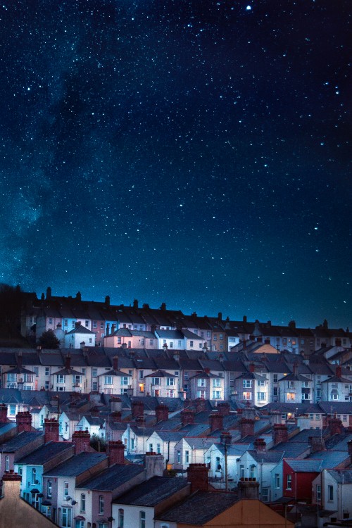 Image white and brown concrete houses under blue sky during night time