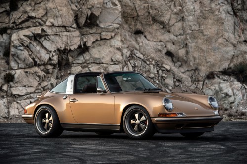 Image orange porsche 911 parked near brown rock