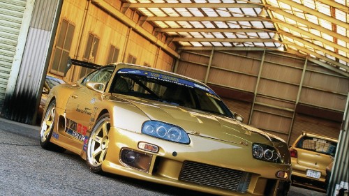 Image white and red bmw m 3 coupe parked in garage