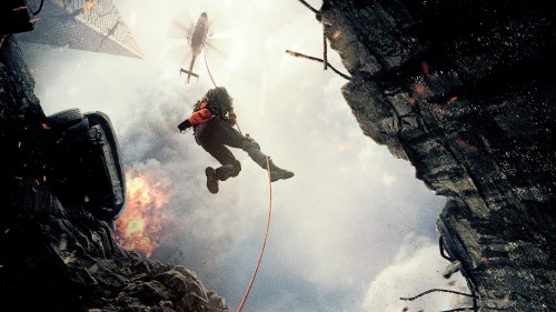 Image man in gray jacket and black pants riding on red and white kite under white clouds