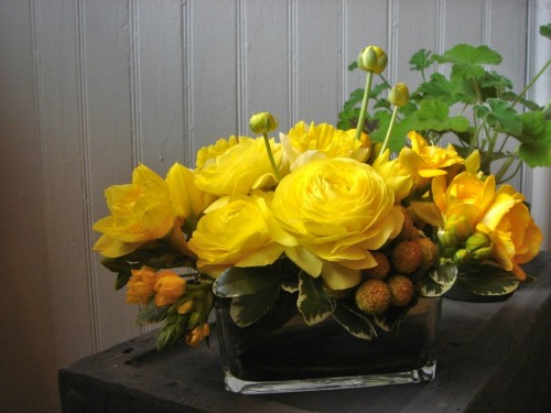 Image yellow flowers on black plastic container