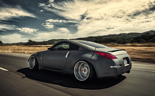 Image silver porsche 911 on road under white clouds and blue sky during daytime