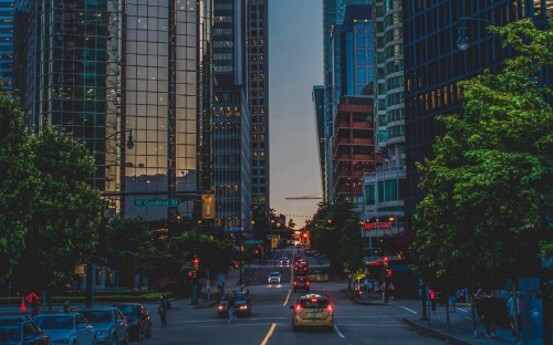 Image cars on road near high rise buildings during daytime