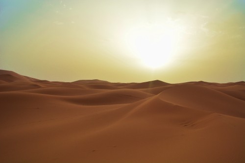 Image sun over desert during daytime