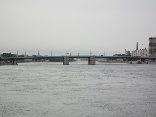 Image brown concrete bridge over body of water during daytime