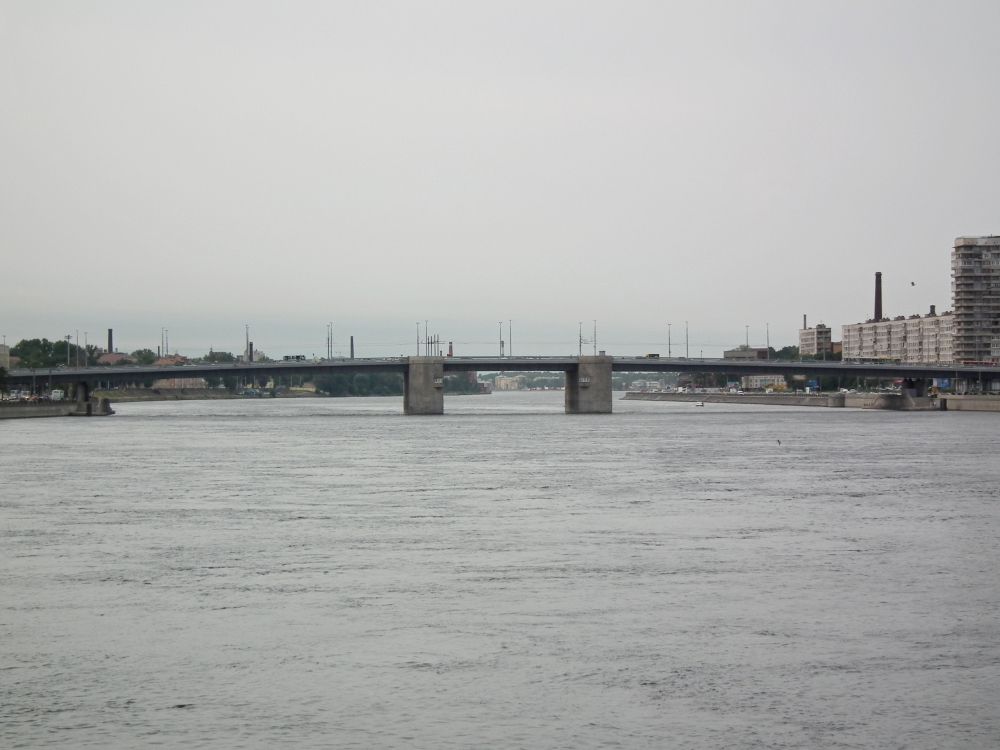 brown concrete bridge over body of water during daytime