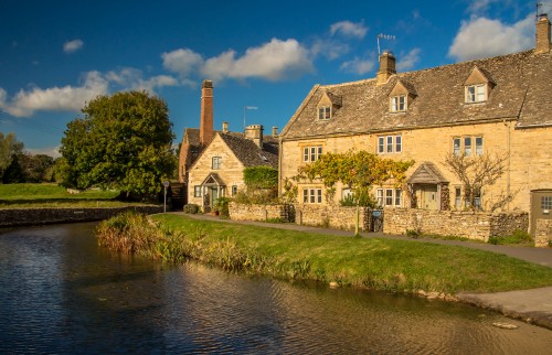 Image brown brick building beside river during daytime