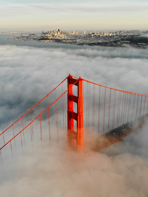 Image red bridge over the clouds