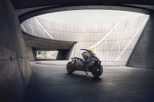 Image black and orange stroller on gray concrete floor