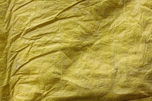 Image yellow textile on brown wooden table