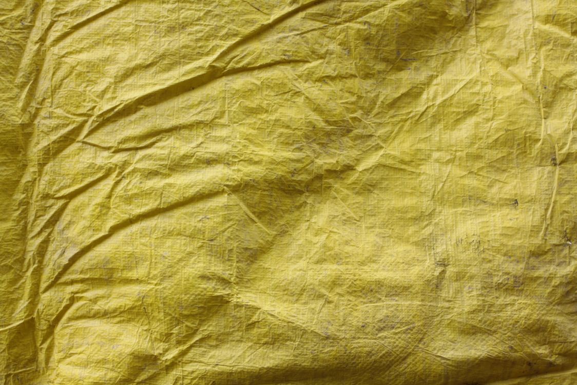 yellow textile on brown wooden table