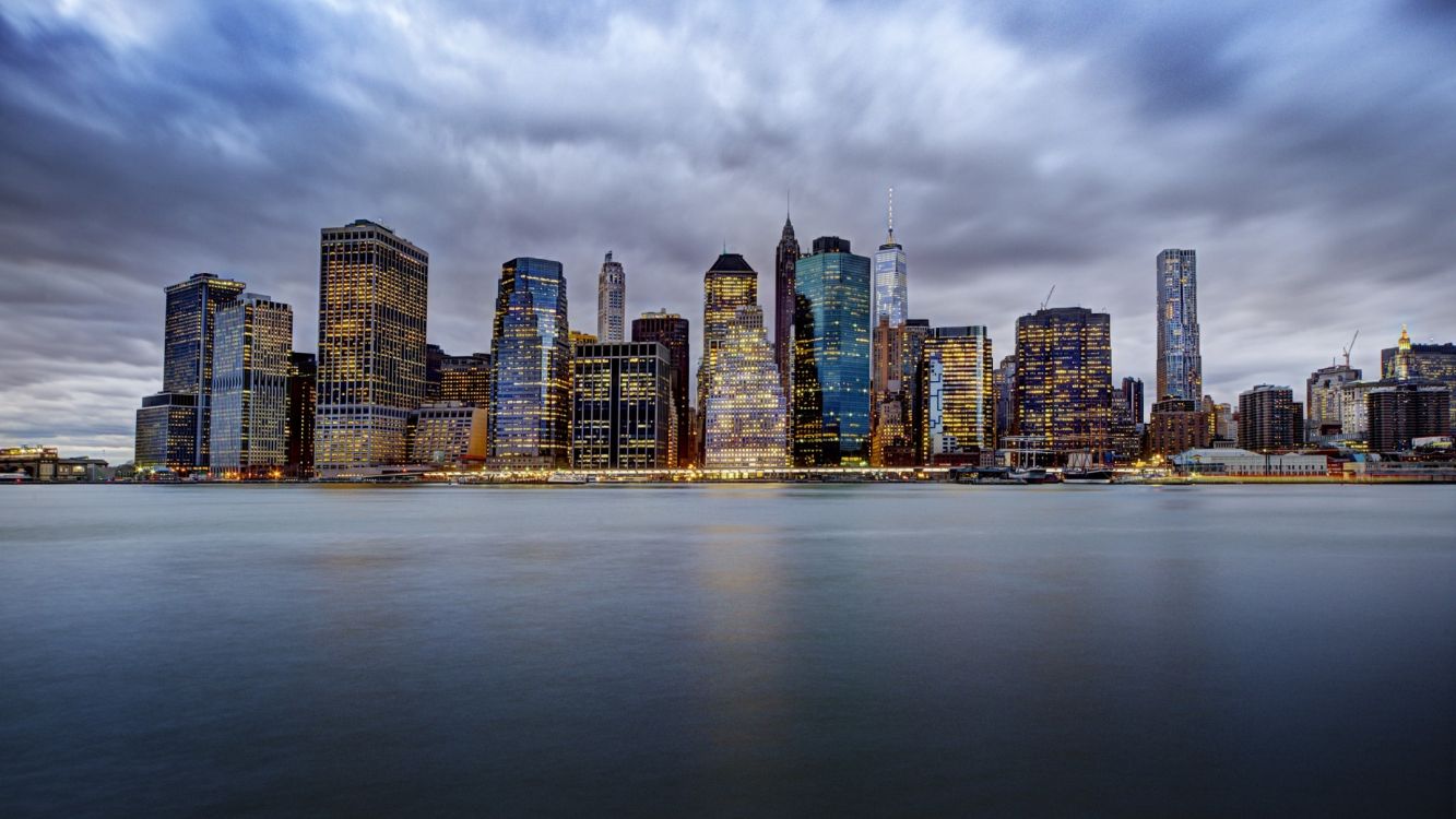 city skyline under cloudy sky during daytime