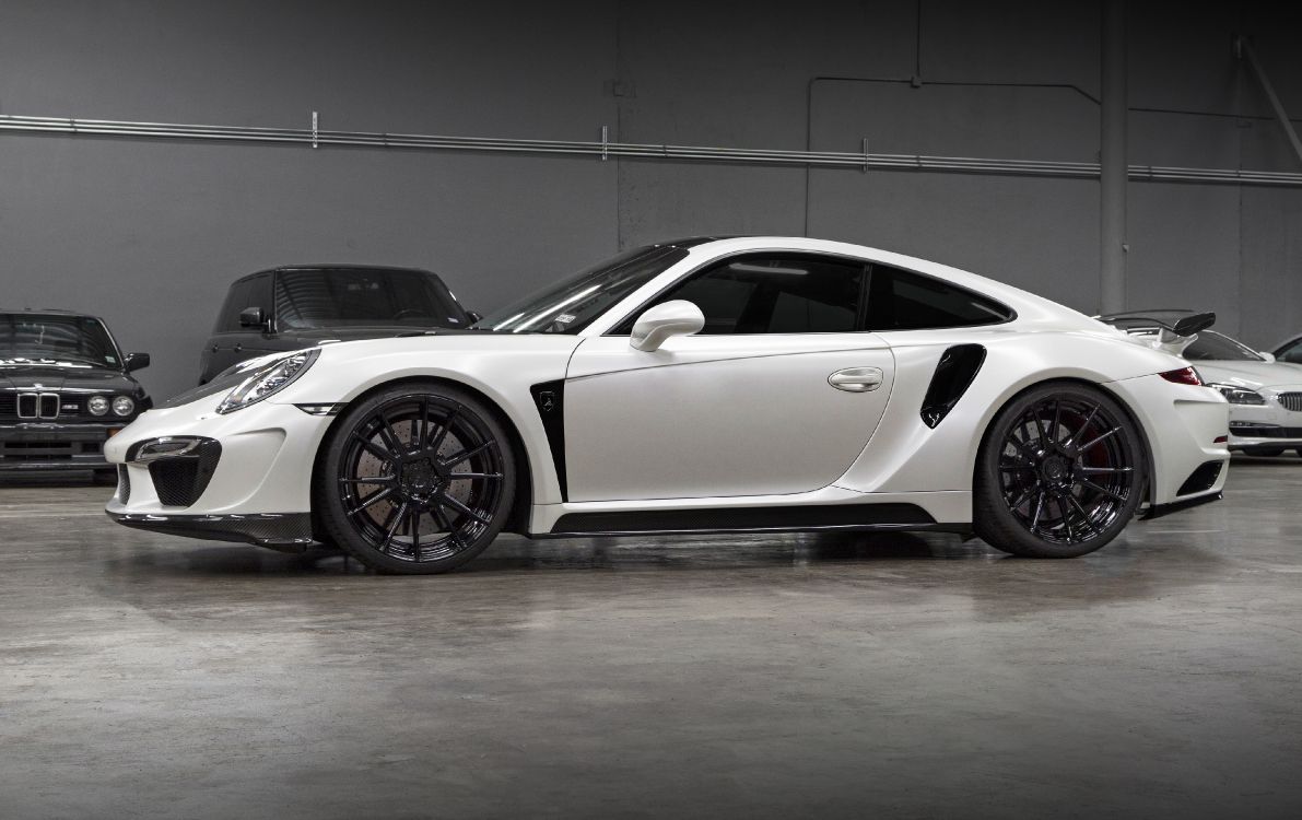 white porsche 911 parked in a room