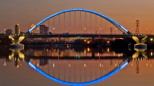 Image blue bridge over water during night time