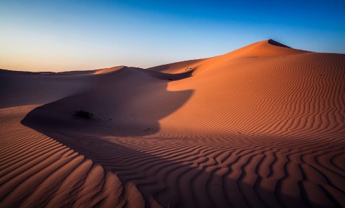 Image brown sand dunes under blue sky during daytime