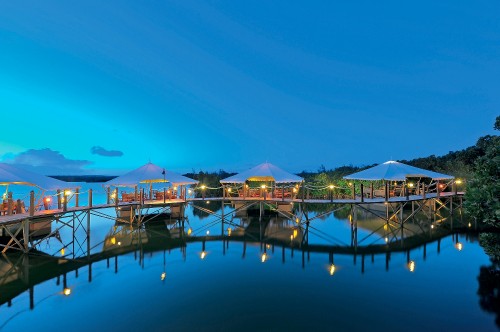 Image white and brown wooden house on dock during night time