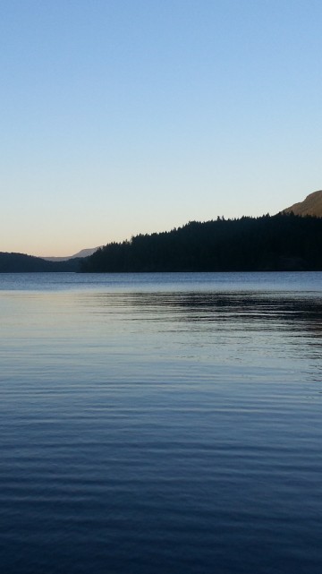 Image body of water near mountain during daytime