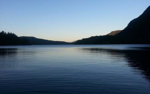 Image body of water near mountain during daytime