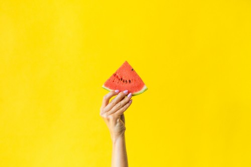 Image person holding orange and yellow cone