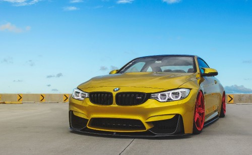 Image yellow bmw car on road during daytime