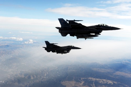 Image fighter jet flying over the clouds during daytime