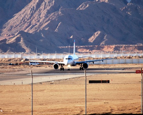 Image white airplane on gray concrete road during daytime