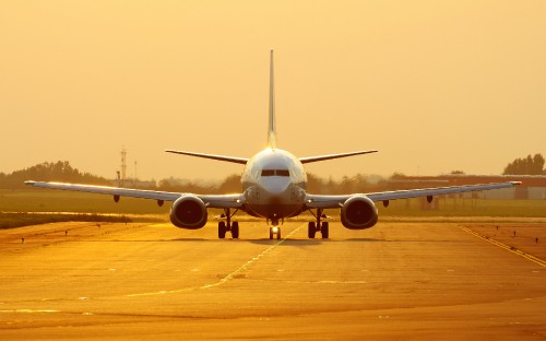 Image white airplane on brown field during daytime