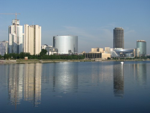 Image city skyline across body of water during daytime