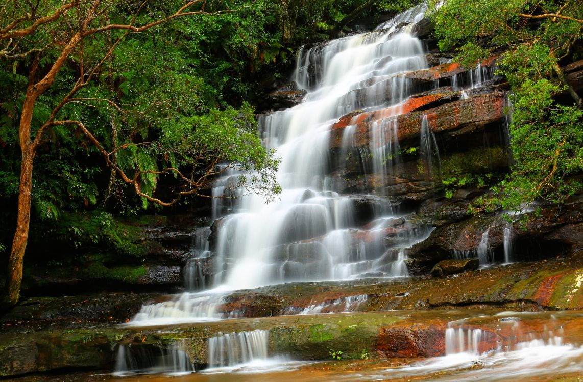 water falls on brown rock