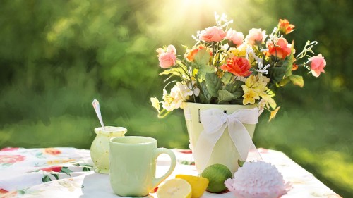Image white ceramic mug with stainless steel spoon on yellow ceramic saucer