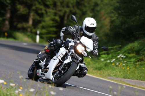 Image man in black helmet riding motorcycle on road during daytime