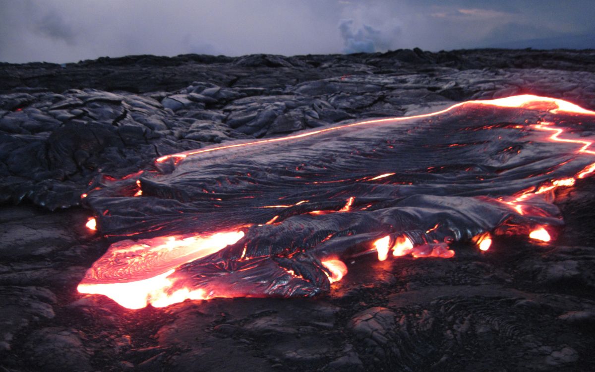 burning wood on rocky ground during daytime