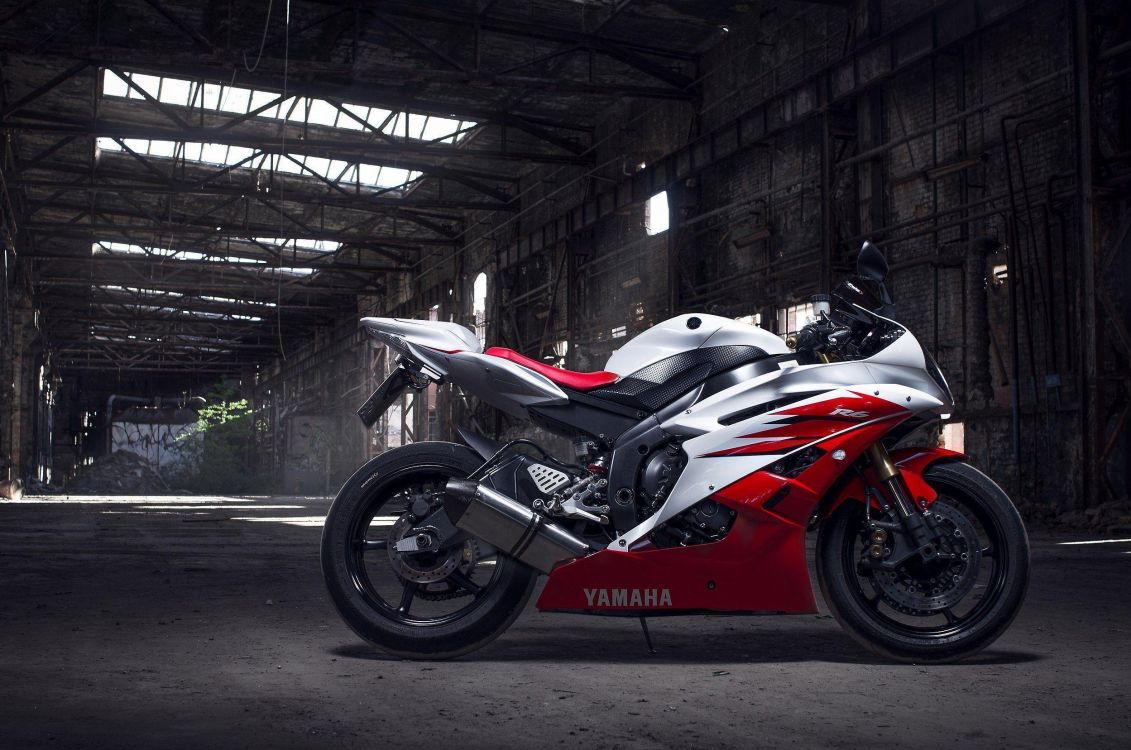 red and black sports bike parked on tunnel