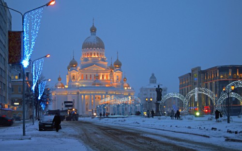 Image people walking on snow covered ground near white and brown concrete building during daytime