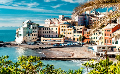 Image white and brown concrete buildings near body of water during daytime