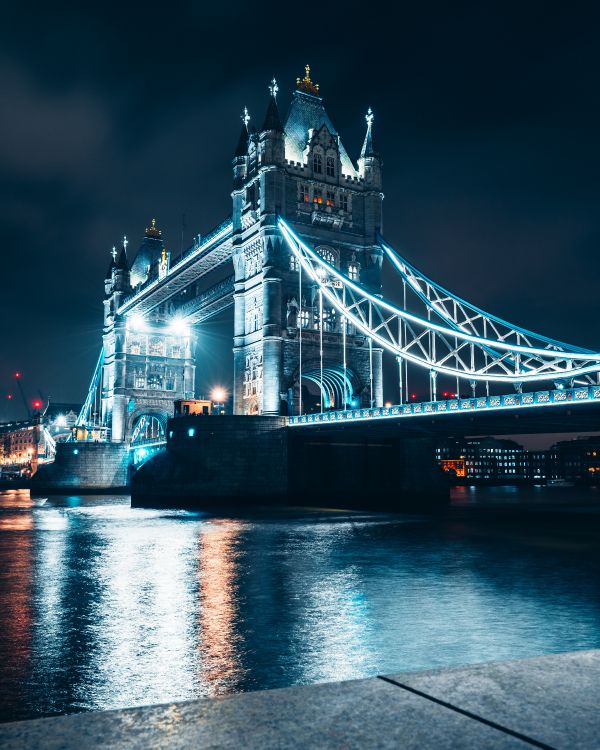 White and Blue Bridge Near City Buildings During Night Time. Wallpaper in 5161x6451 Resolution
