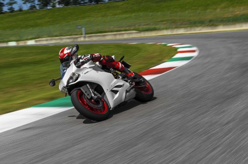 Image white and black sports bike on track field during daytime