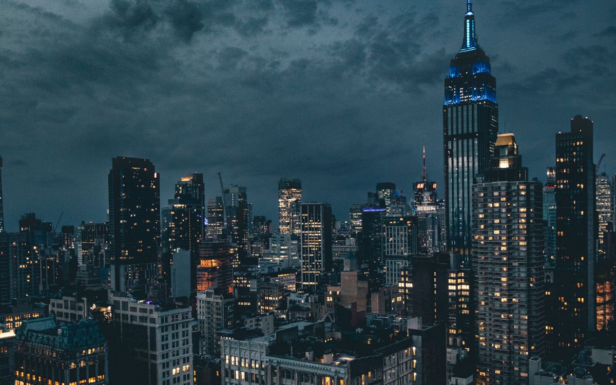 high rise buildings under gray clouds