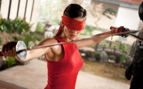 Image woman in red tank top holding her hair