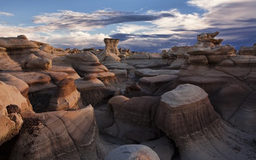 Image brown rock formation under blue sky and white clouds during daytime